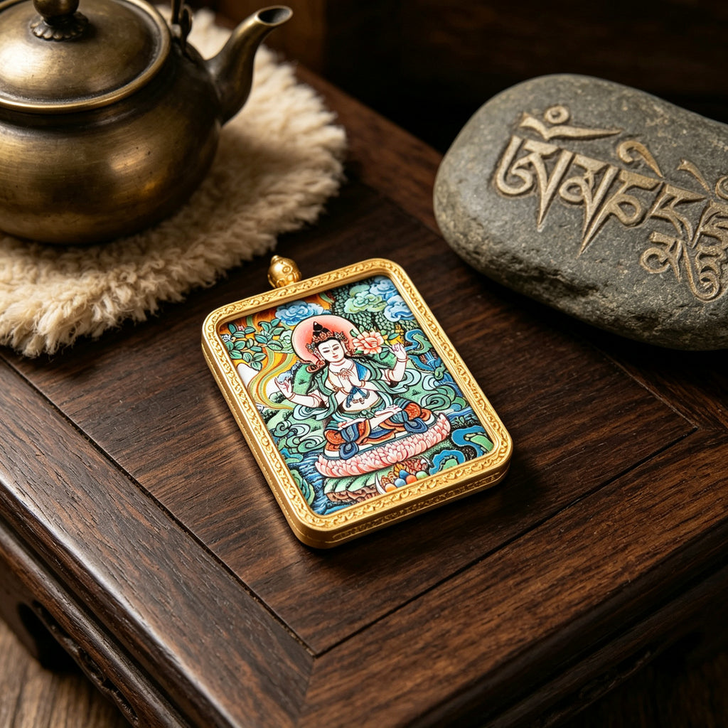 Hand-painted Tibetan miniature art pendant depicting Four-Armed Avalokiteshvara in a gold-tone frame — lifestyle view